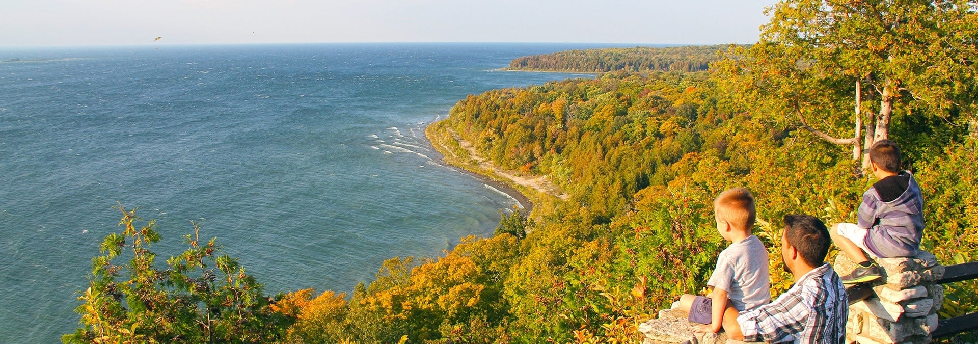 Parks in Door County A group of boys sitting on a cliff looking out at the lake